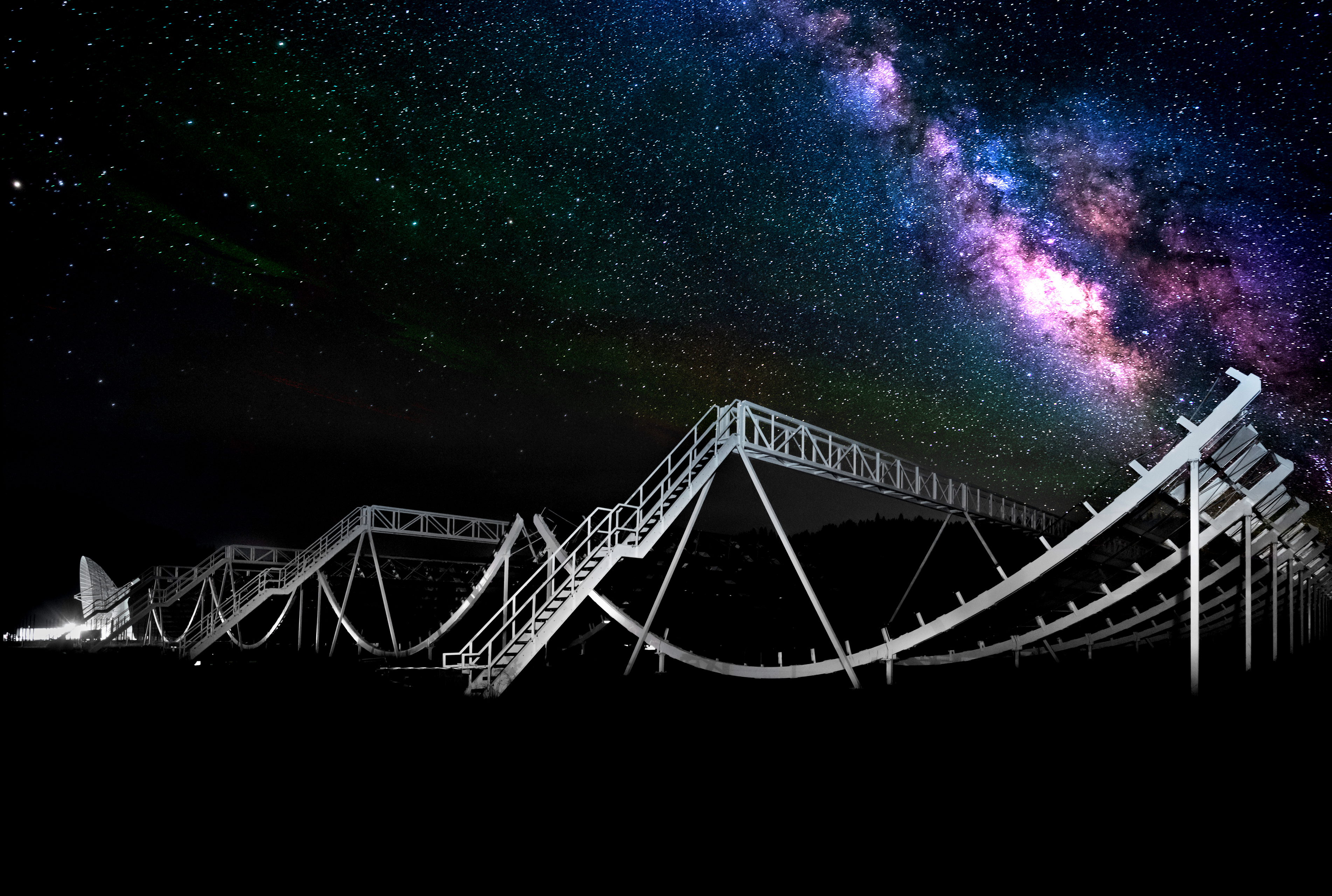 Enormous scaffolding of the CHIME telescope with a backdrop of starry sky and Milky Way.