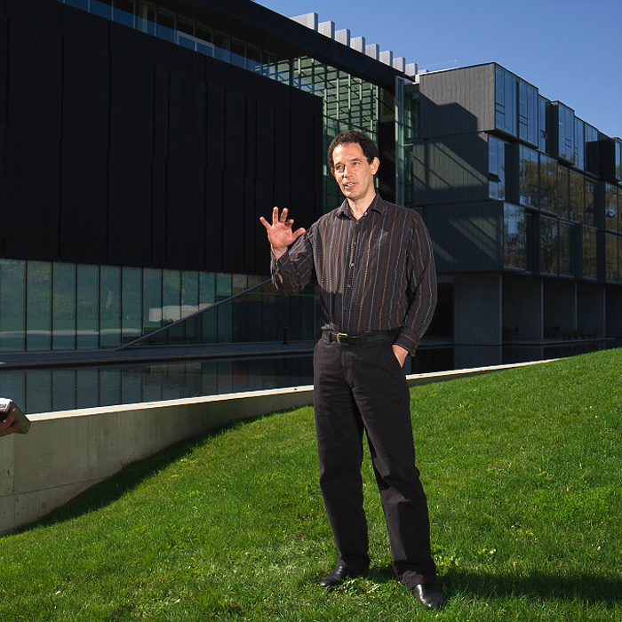 Pr. Neil Turok standing in front of Perimeter Institute