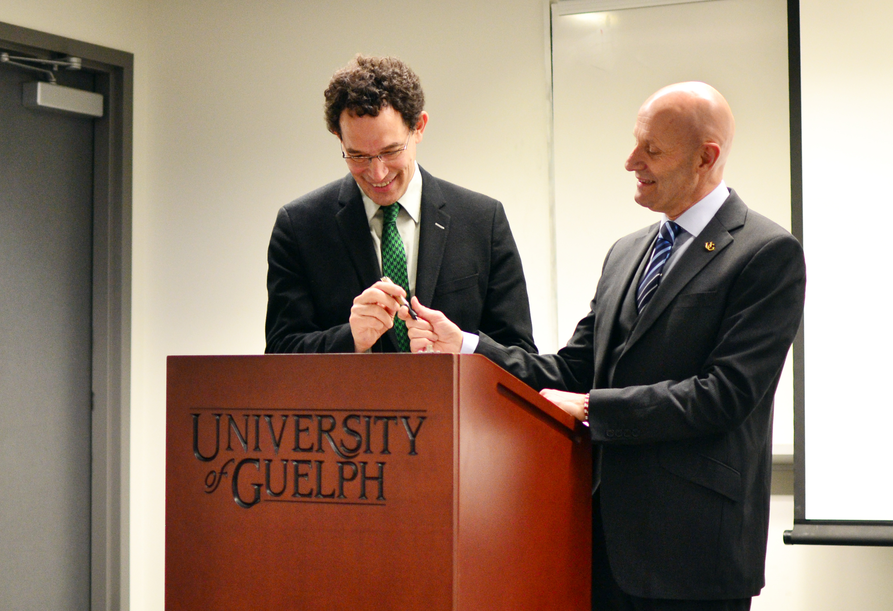 Neil Turok, PI Director and founder of AIMS, and Alastair Summerlee, University of Guelph President, signed a five-year agreement in support of the One for Many scholarship campaign on April 20, 2011