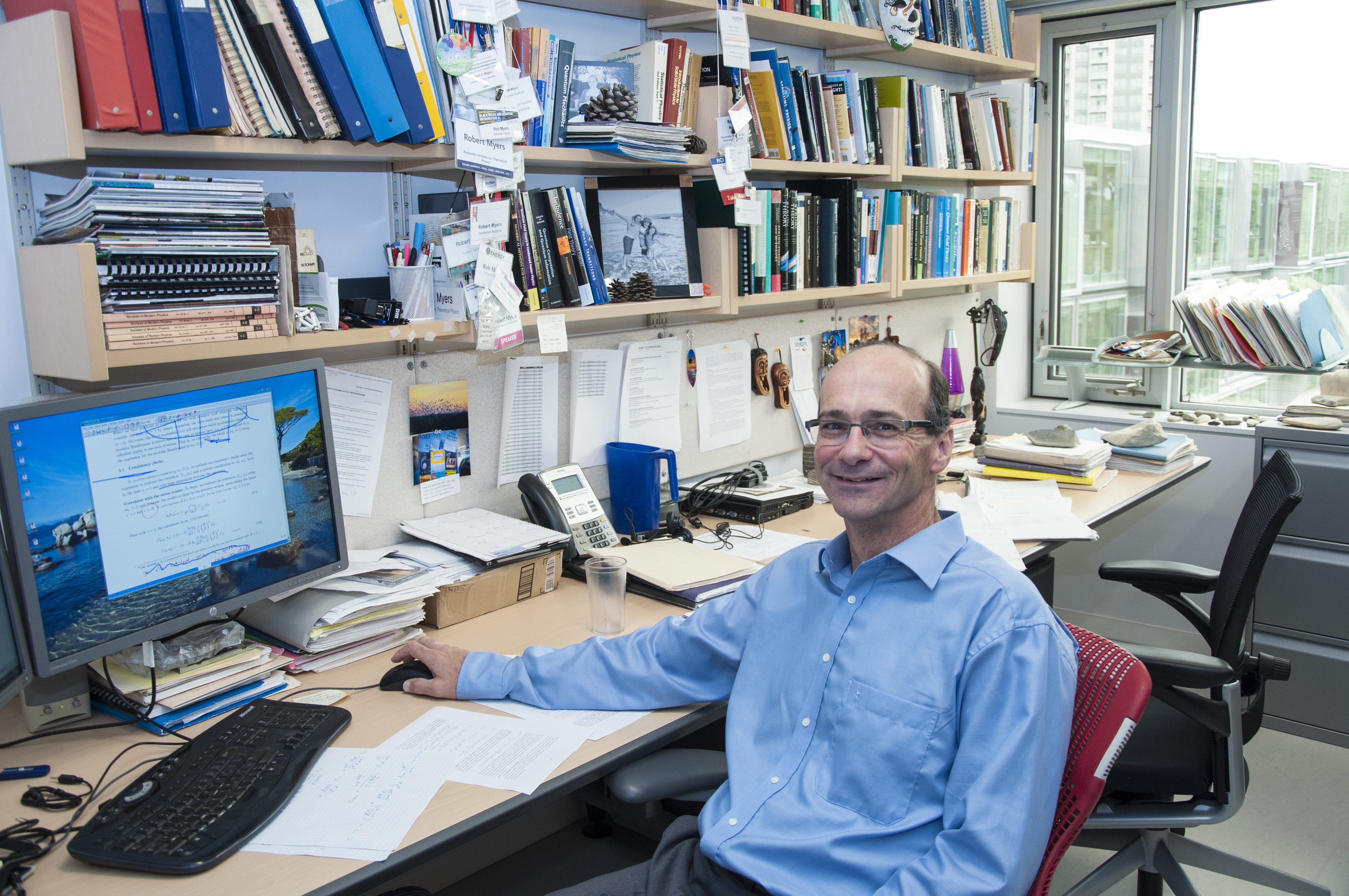 Rob Myers sitting behind his desk at Perimeter Institute