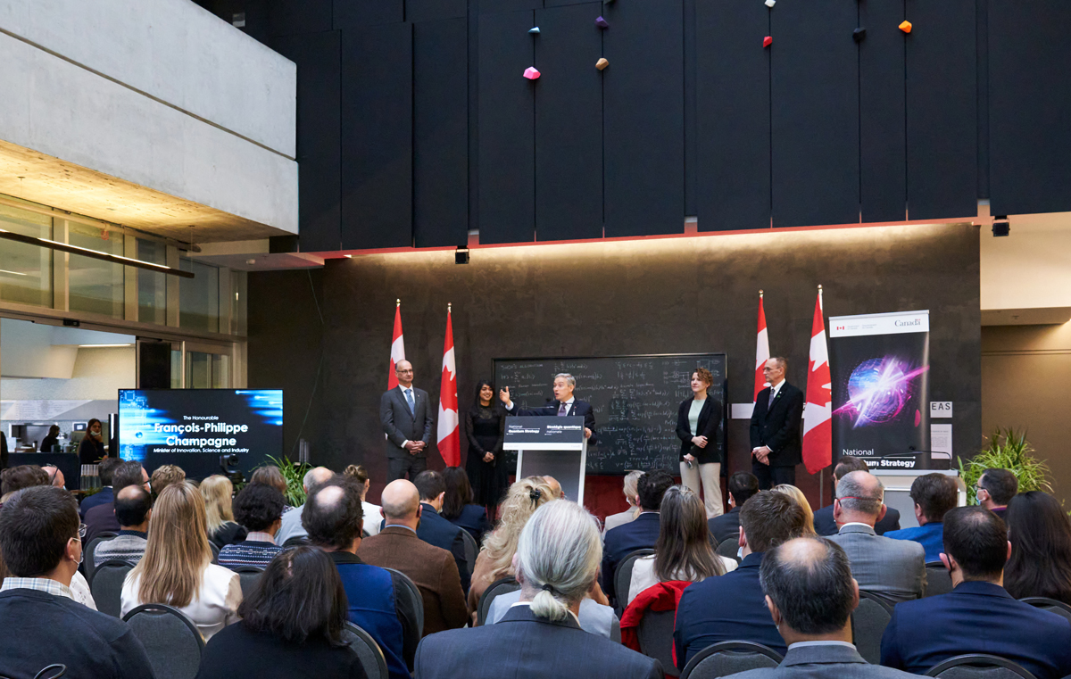 Government officials giving presentation on a stage in an atrium