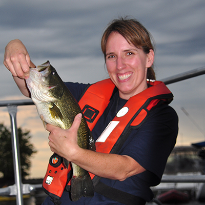Women smiling holding large mouth bass