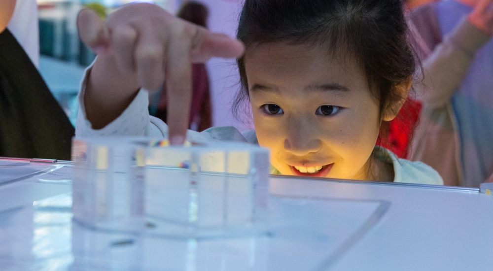 little girl making an experiment with wonder in her eyer at brainstem festival at Perimeter Institute