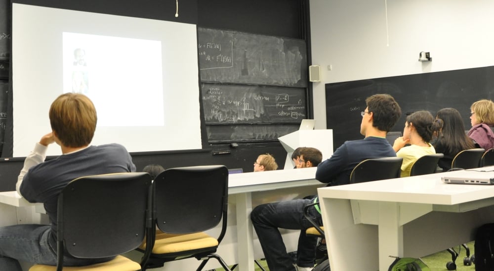 Students in a lecture hall listening to a seminar