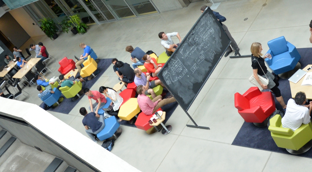 Groups of people interacting with each other in large atrium