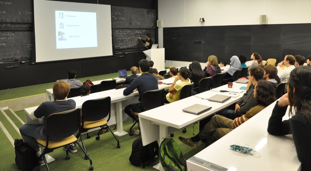 Students sitting classroom style in lecture room listening to teaching