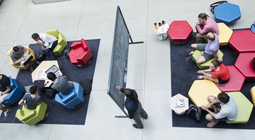 Aerial shot of groups of people interacting in an atrium