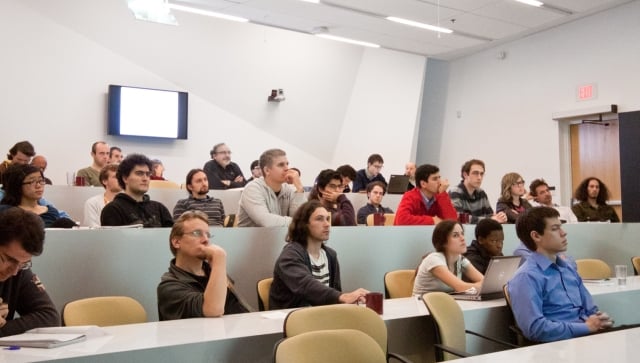 People sitting in a lecture room listening to a presentation