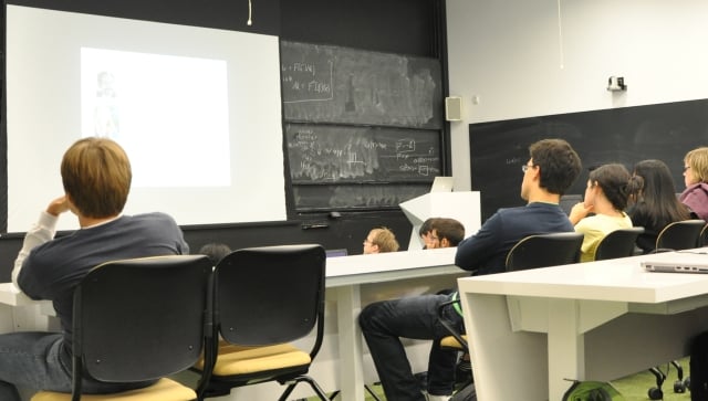 Students in a lecture hall listening to a seminar