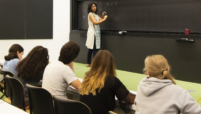 Woman teaching to a group of five students