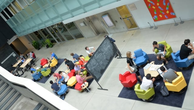 Aerial shot of groups of people interacting in an atrium