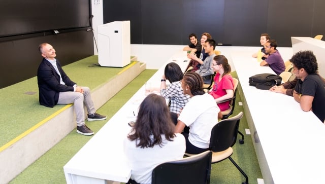 Man talking with a group of students