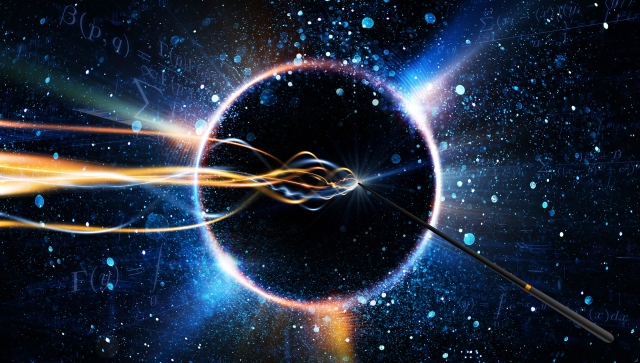 Abstract image of galaxy of stars with a ring of light, magic wand and yellow and blue light swirls coming from the tip