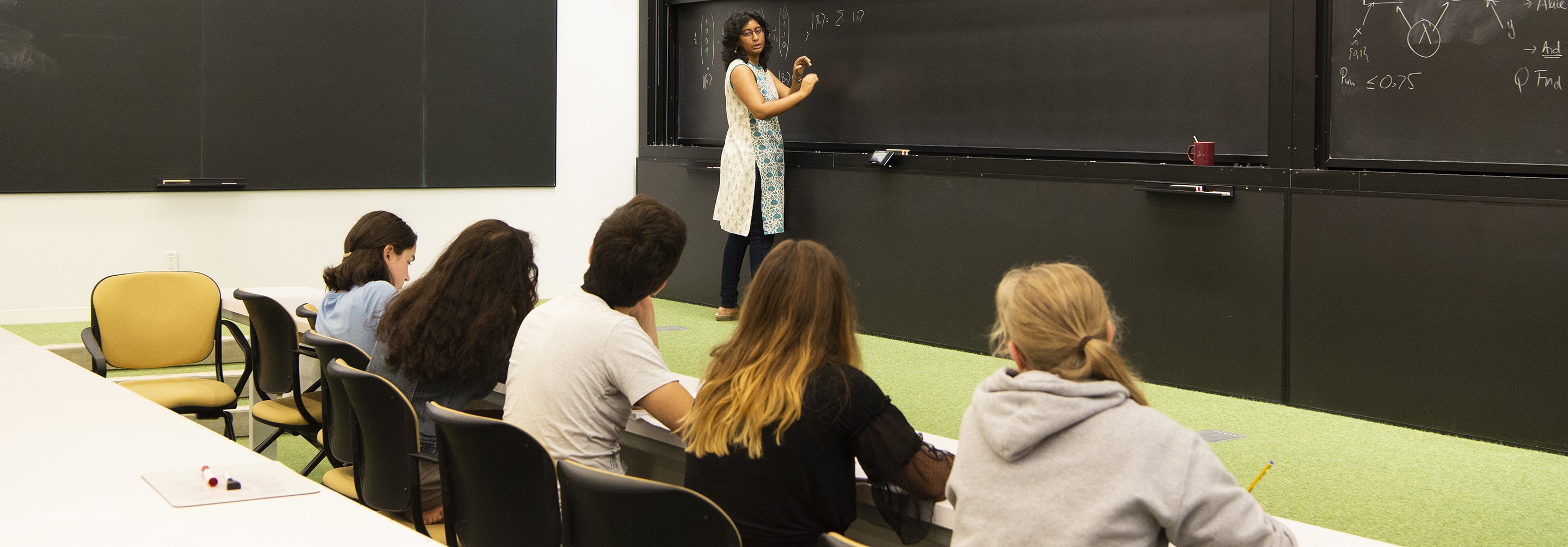 Woman teaching to a group of five students
