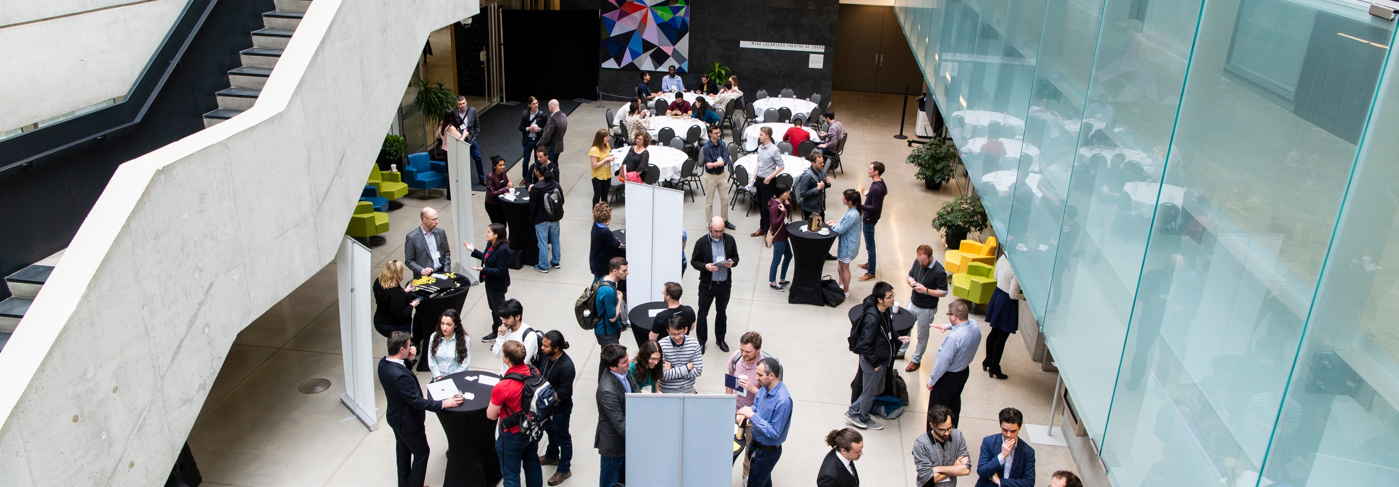 Aerial shot of groups of people interacting in an atrium