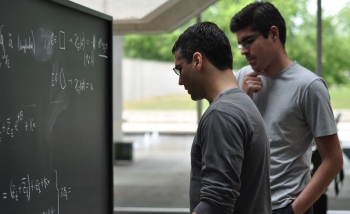 João Caetano and Jonathan Toledo collaborating on a blackboard in the Atrium