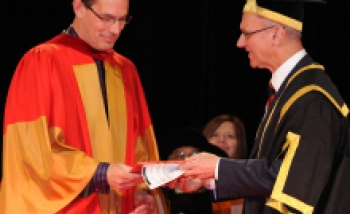 Turok receiving his Honorary doctorate from the University of Guelph from the hands of University president Alastair Sommerlee