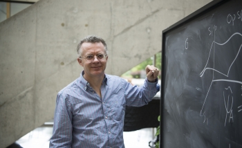 portrait of Lucien Hardy by a blackboard