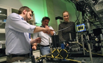 A group of researchers working together in a lab on an experiment