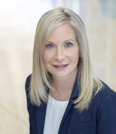 Aerial portrait of a woman with blonde hair wearing a navy suit