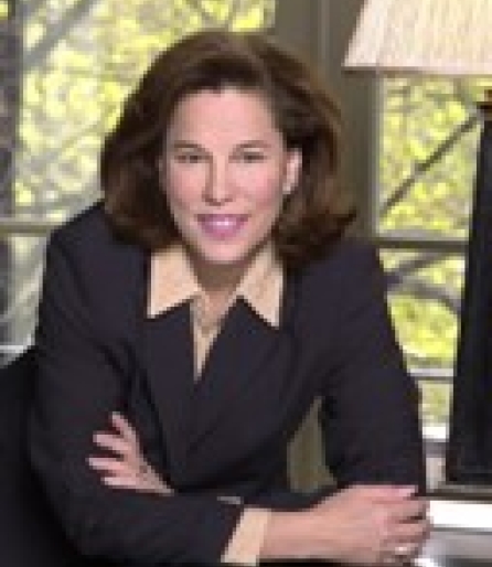 Portrait of a woman in a suit posing in an office